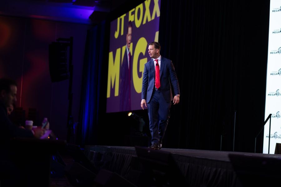 JT Foxx speaking at a past Mega Success event