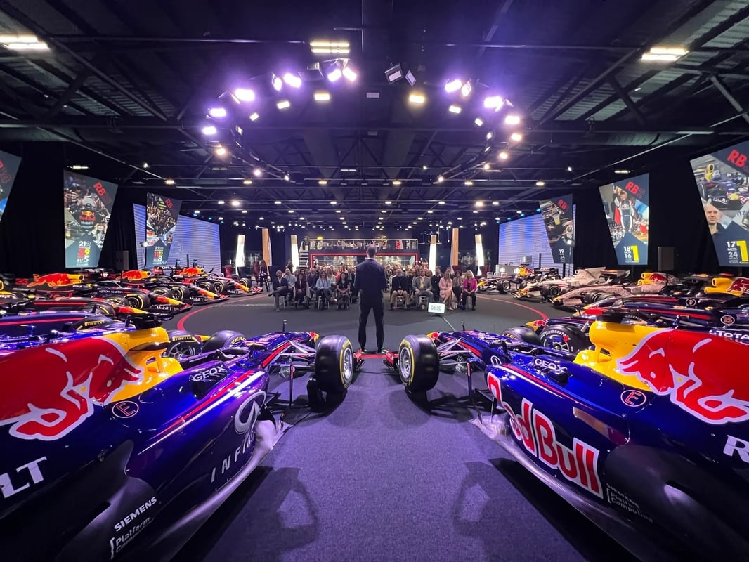 Business event surrounded by Red Bull Racing cars